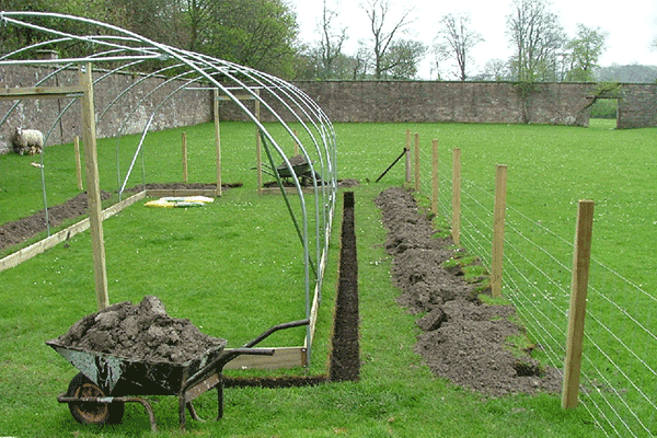 a polytunnel being built to stop blowing away in the wind