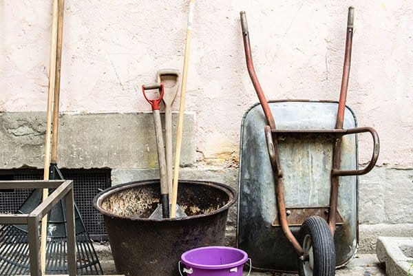 gardening tools and a sunhat on a round table