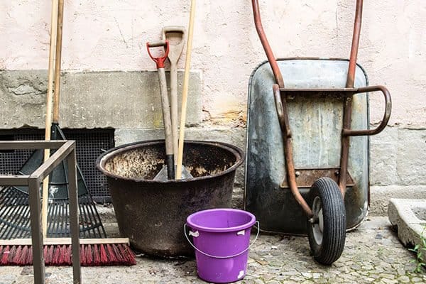 gardening tools against a wall
