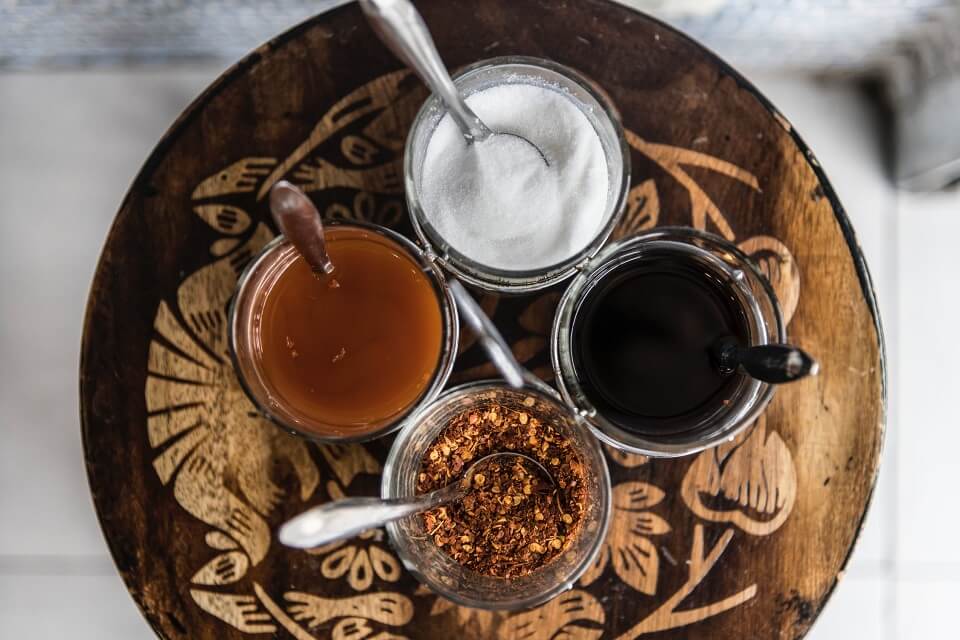 plate with jars of vinegar and sugar