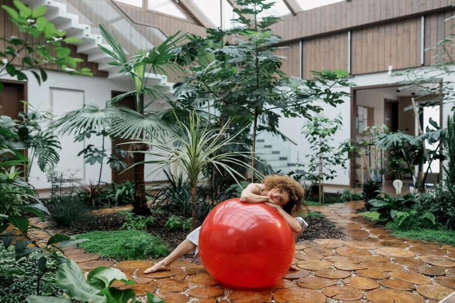 a woman in an enclosed courtyard garden connecting indoor outdoor rooms