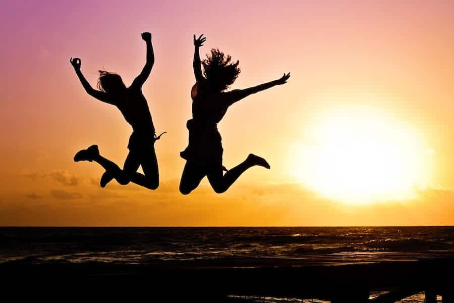 two happy people jumping