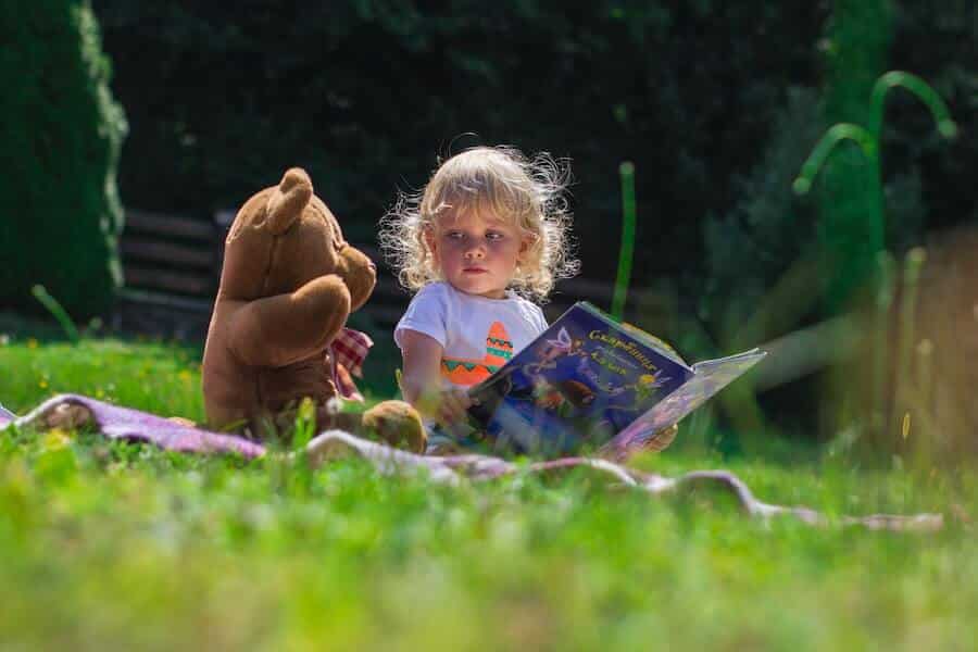 child reading outdoors