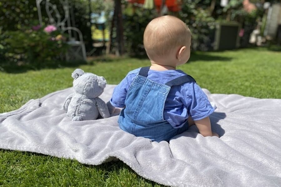 child sat in garden