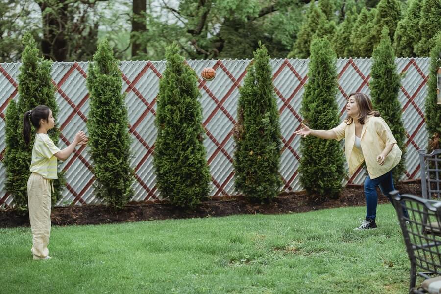 a mother and daughter playing in a wellbeing garden