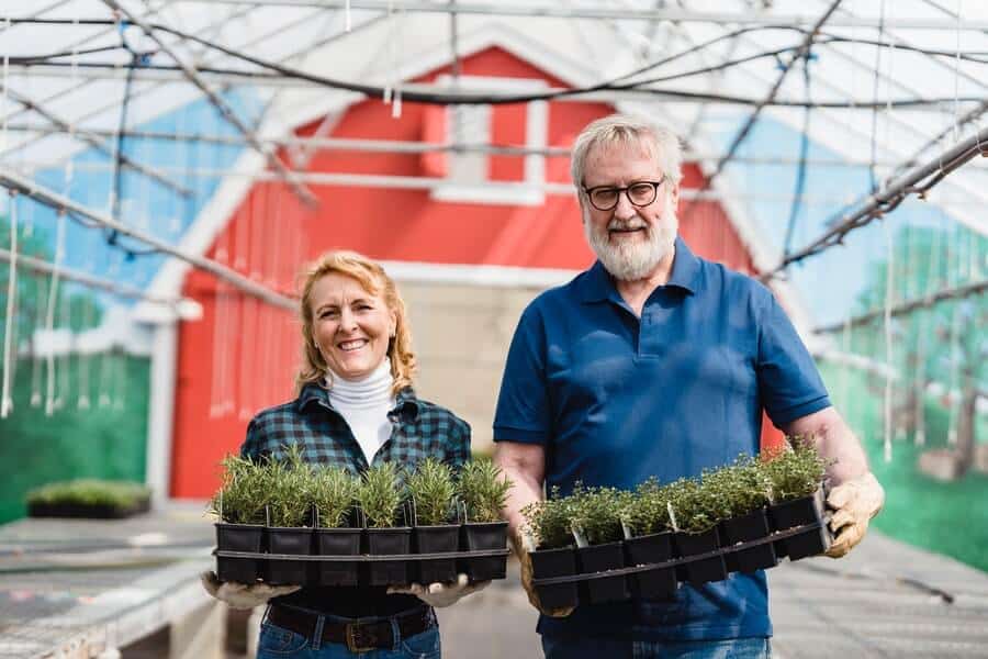 two gardners smiling