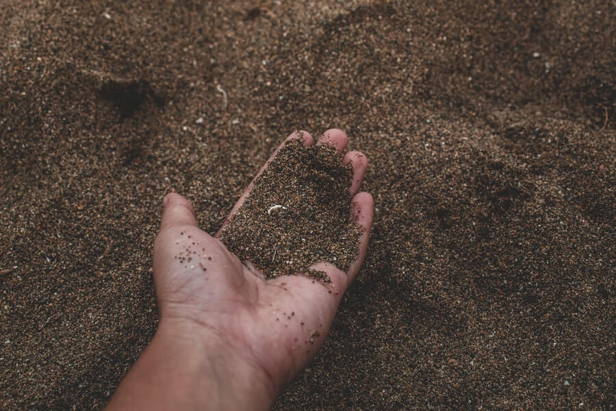 person picking up soil