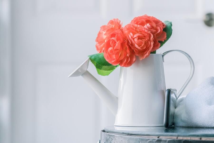 watering can with flowers