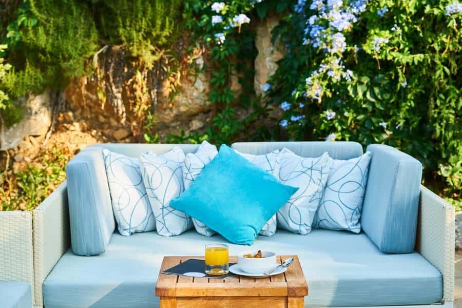 a blue sofa in a garden seating area