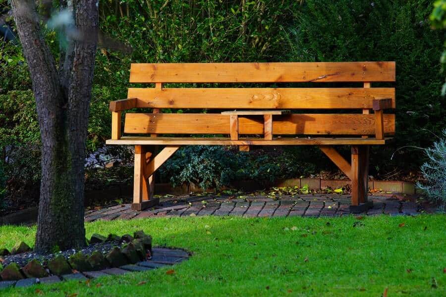 a two seater garden bench in a garden seating area