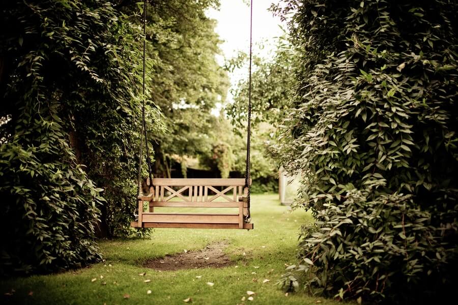 hanging bench in a windy garden
