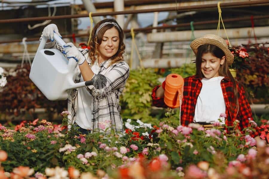 woman and child watering flowers