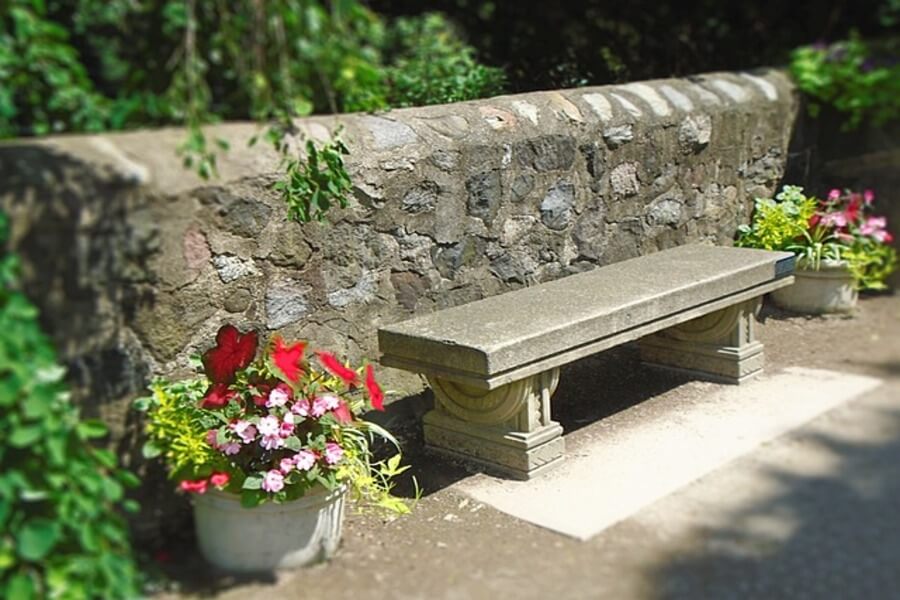 stone garden wall with bench