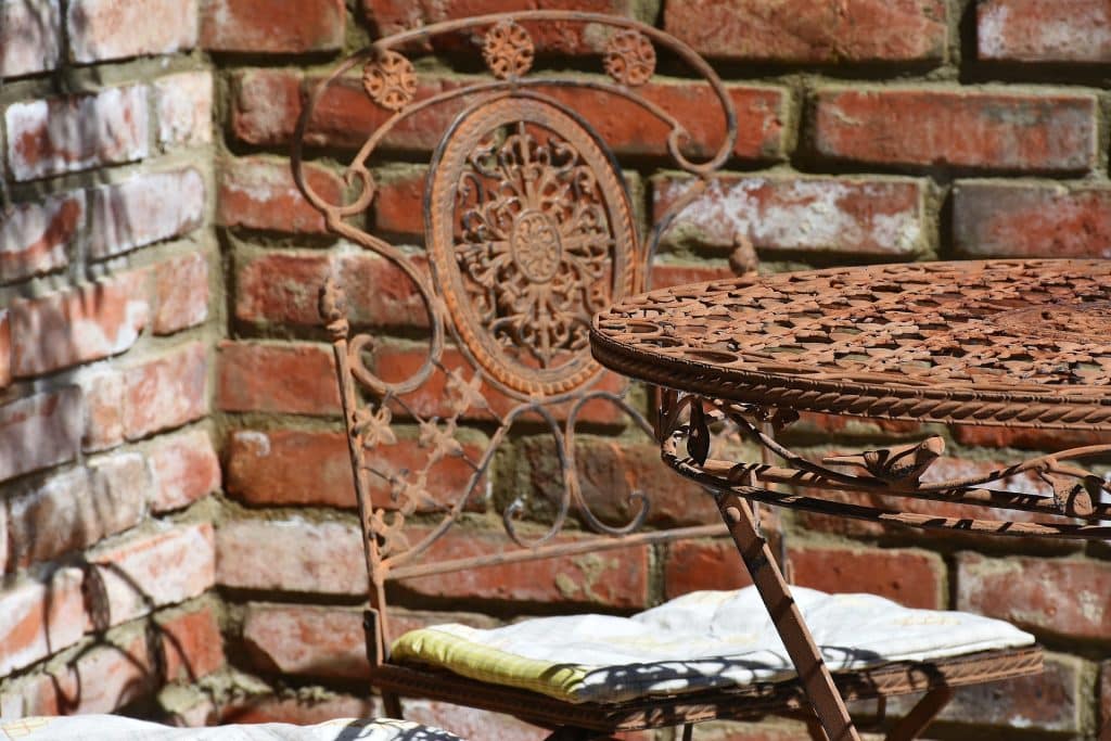 outdoor table by brick garden wall