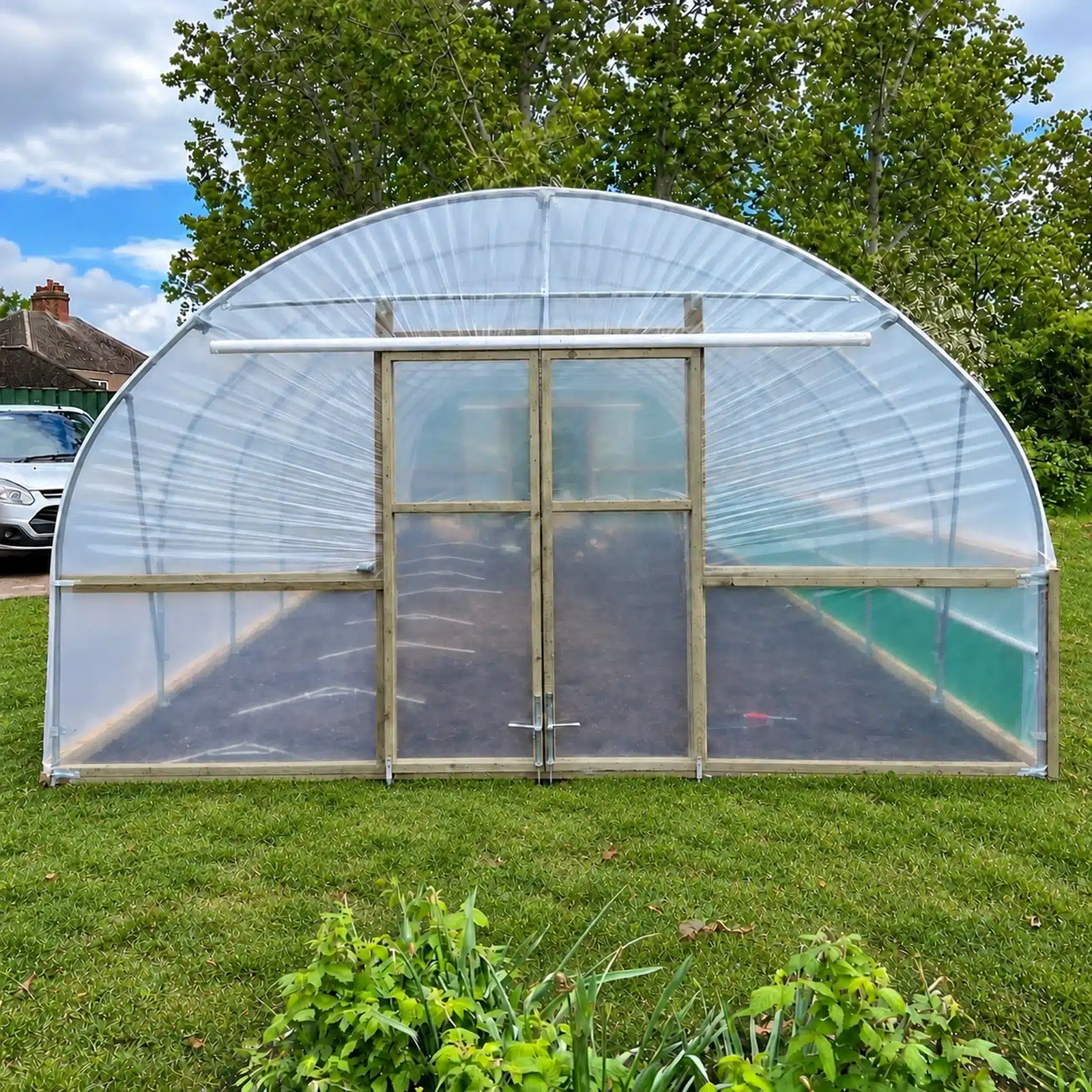 Closed double sliding doors on a polytunnel with lower ventilation panels