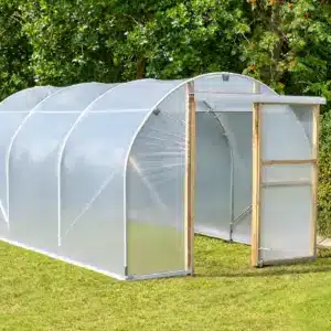 Timber sliding door open at the entrance of a garden polytunnel